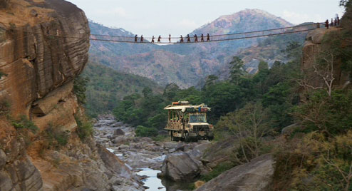A Safari vehicle passes under the bridge for Indiana Jones and the Temple of Doom