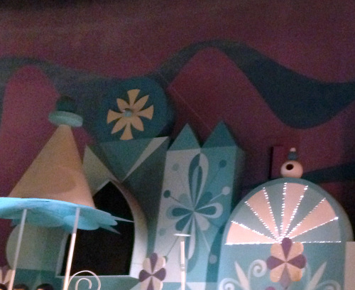 low tech special effects allow the cyclist to ride across a wire in it's a small world