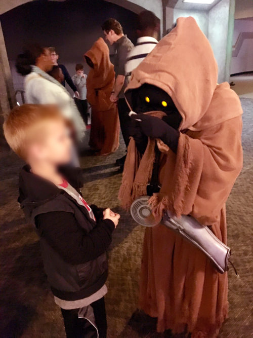 Young boy seen trading with jawas at Star Wars Launch Bay