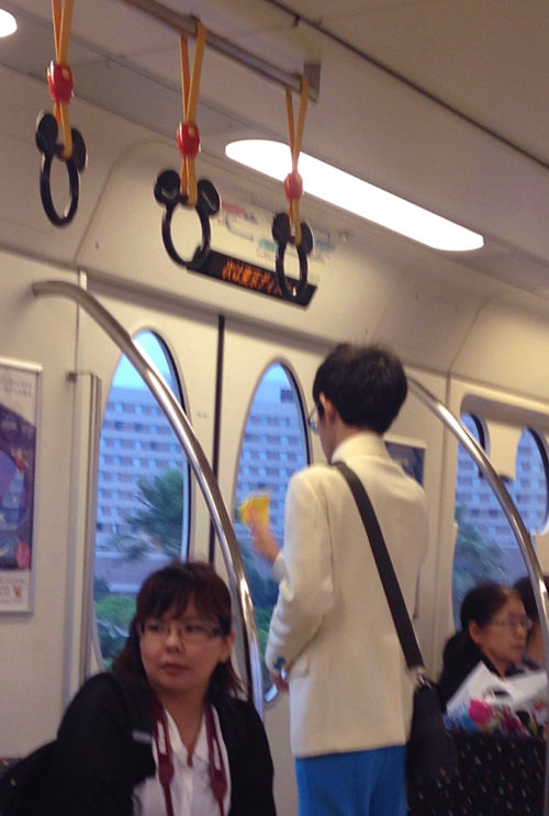 Tokyo Disney monorail Cast Member cleaning the monorail while in transit