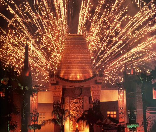 The Chinese Theatre at Disney's Hollywood Studios backlit by fireworks.